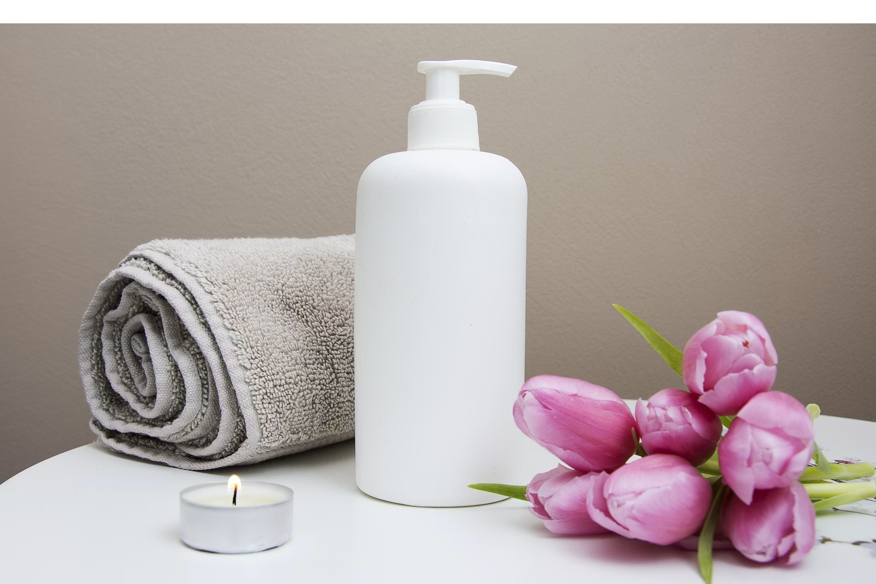 Luxury spa treatment room with candles and towels